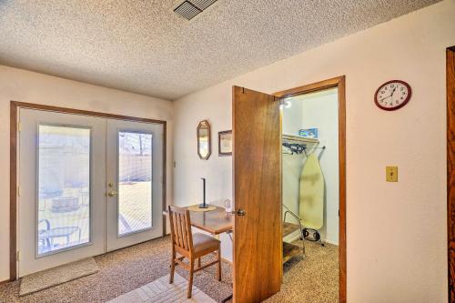 a room with a table and a chair and a clock at Midland Vacation Rental Close to Downtown in Midland