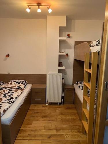 a bedroom with two bunk beds and a ladder at Bjelasnica View Apartment in Bjelašnica