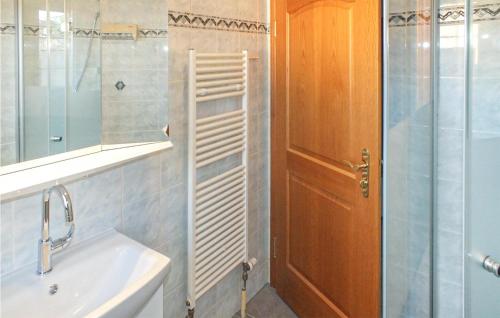 a bathroom with a sink and a shower and a mirror at Amazing Apartment In Berlin-bohnsdorf With 1 Bedrooms And Wifi in Berlin