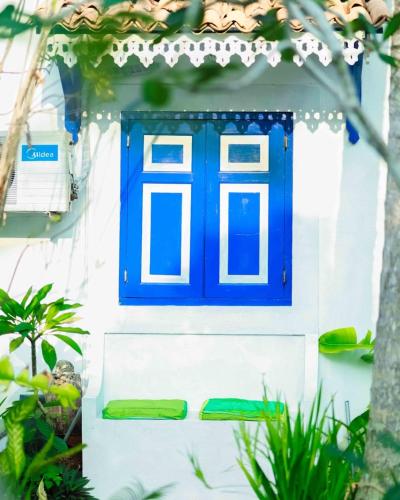 a blue door on a white house with plants at Sriyan Villa in Beruwala