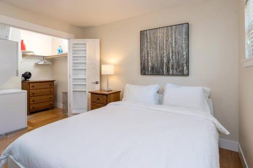 a bedroom with a large white bed and a dresser at Downtown Mountain View Perfect for G0ogel in Mountain View