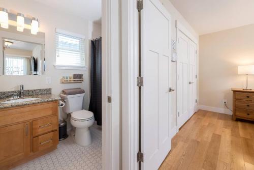 a bathroom with a toilet and a sink and a mirror at Downtown Mountain View Perfect for G0ogel in Mountain View