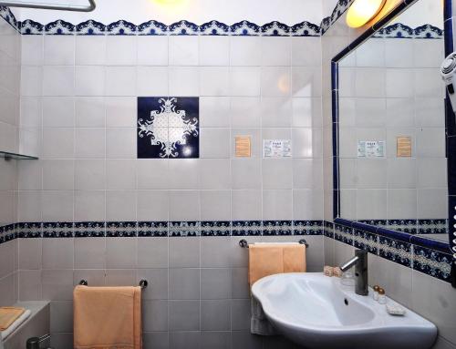 a bathroom with a sink and a mirror at Hotel Aura in Vulcano