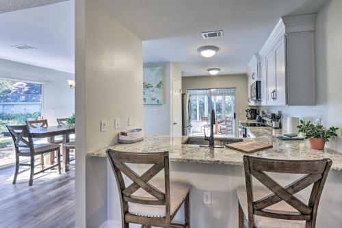 a kitchen and living room with a counter and chairs at Family-Friendly Home Near Destin Beaches in Niceville