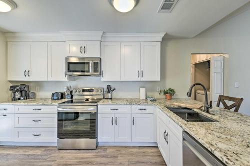 a kitchen with white cabinets and stainless steel appliances at Family-Friendly Home Near Destin Beaches in Niceville