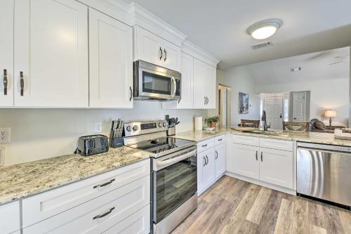 a kitchen with white cabinets and marble counter tops at Family-Friendly Home Near Destin Beaches in Niceville