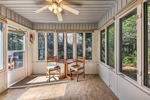 a screened porch with a table and chairs and windows at Family-Friendly Home Near Destin Beaches in Niceville