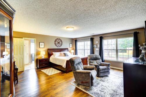 a bedroom with a bed and two chairs at Browns Summit Vacation Rental with Fire Pit! in Monticello