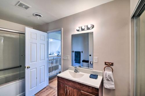 a bathroom with a sink and a mirror at Spacious Chesapeake Home with Pool Table! in Chesapeake