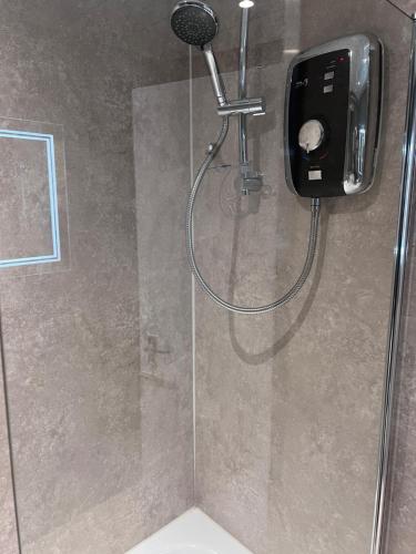 a shower in a bathroom with a shower at Crags View Apartment On The Royal Mile in Edinburgh