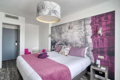 a bedroom with a large bed with a purple blanket at Best Western Le Vinci Loire Valley in Amboise
