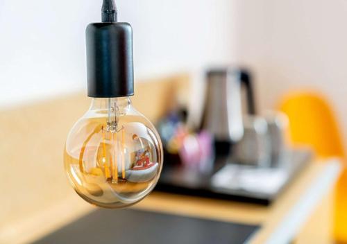 a light bulb with a picture of a person in it at Best Western Le Vinci Loire Valley in Amboise