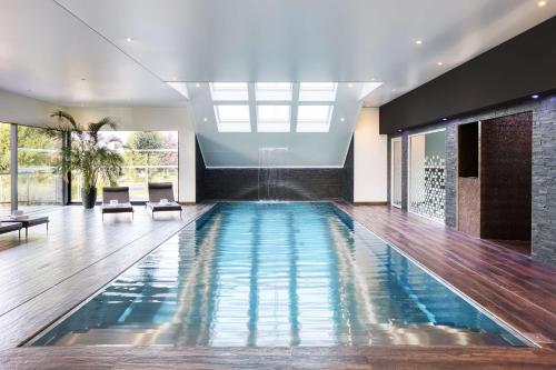 a swimming pool in a house at Best Western Plus Le Fairway Hotel & Spa Golf d'Arras in Anzin-Saint-Aubin