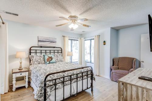 a bedroom with a bed and a ceiling fan at Edisto Bliss in Edisto Island