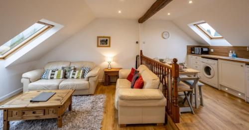 a living room with a couch and a table at Achintee Cottages No 2 in Fort William