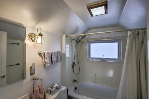 a bathroom with a tub and a shower and a window at Charming Lake Ripley Cottage with Water View! in Cambridge