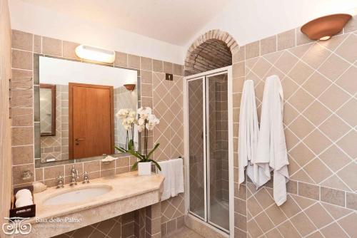 a bathroom with a sink and a mirror at Apartments in Pula Sardinien Cagliari Provinz 43440 in Foxiʼe Sali