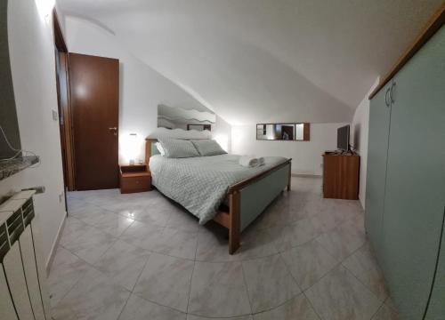 a bedroom with a bed in a room with a staircase at Residenza Infante in Avezzano