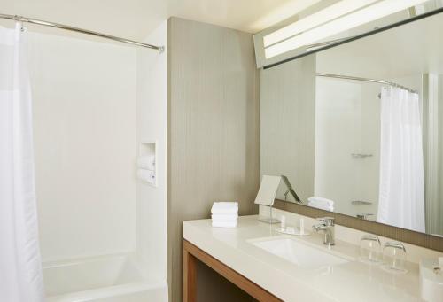 a bathroom with a sink and a mirror at Courtyard by Marriott Lake George in Lake George