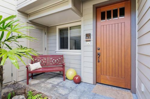 a red door of a house with a red bench at Mauna Lani Palm Villas D-2 Corner Unit Historic View in Waikoloa
