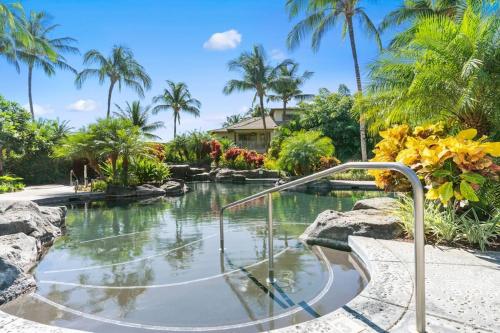 a plunge pool in a resort with palm trees at Mauna Lani Palm Villas D-2 Corner Unit Historic View in Waikoloa