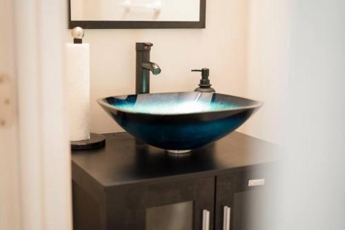 a blue bowl sink sitting on top of a counter at Entire ATL Airport 2 Story House in Atlanta