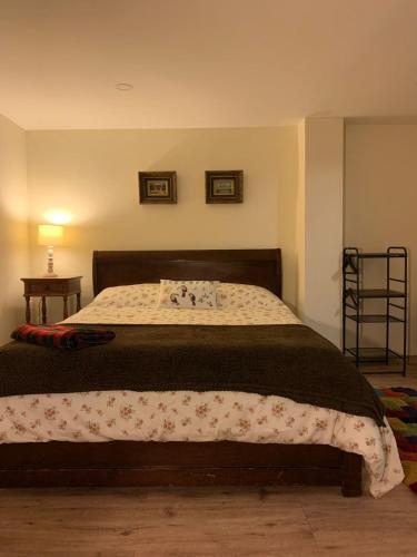a bedroom with a bed with a blanket on it at HOBU MONTAÑA in La Calera
