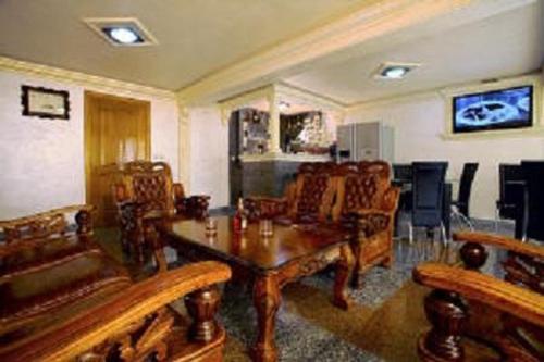 a living room with wooden furniture and a table at Villa M in Dobra Voda