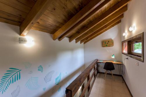 a room in a house with a desk and a window at Solar Selvana - Casas de montaña in Villa La Angostura