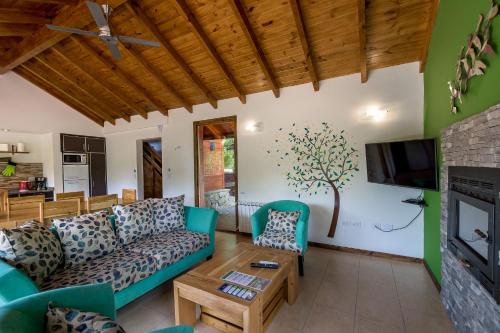 a living room with a couch and a fireplace at Solar Selvana - Casas de montaña in Villa La Angostura