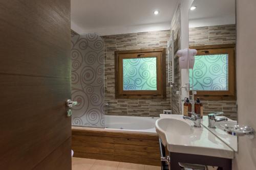 a bathroom with a sink and a bath tub at Solar Selvana - Casas de montaña in Villa La Angostura