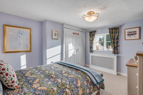 a bedroom with a bed and a window at The Old Laundry in Horsham Saint Faith