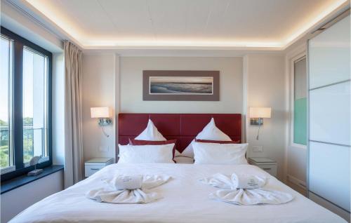 a bedroom with a large bed with two towels on it at Princess in Binz
