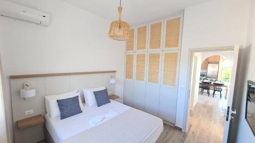 a bedroom with a bed and a hallway with a dining room at Villa Stamos in Plimmiri