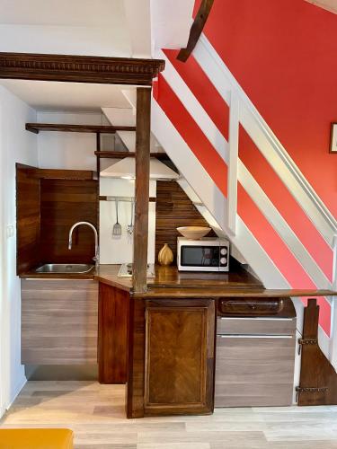 a kitchen with a sink and a staircase at Loreto LYA SEA VIEW APARTMENTS in Rovinj