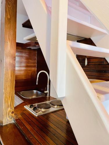 a kitchen under the stairs with a sink at Loreto LYA SEA VIEW APARTMENTS in Rovinj