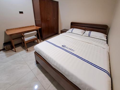 a large bed in a room with a desk and a bed sidx sidx sidx at Global Residency in Kota Kinabalu