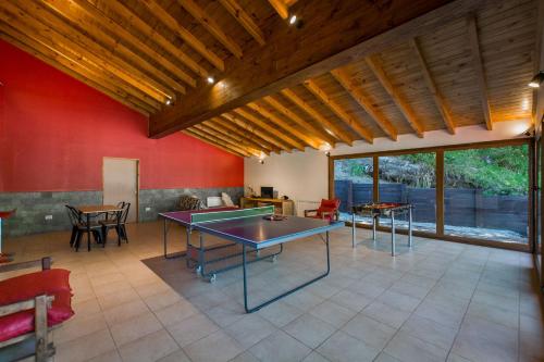 a living room with two ping pong tables in it at Solar Selvana - Casas de montaña in Villa La Angostura