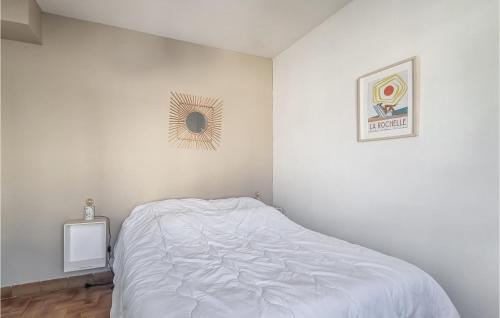 a white bedroom with a bed and a mirror at Amazing Home In Les Portes-En-Ré in Les Portes