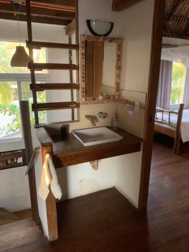 a bathroom with a sink and a bunk bed at Cabo tortugas - casa in Monterrico