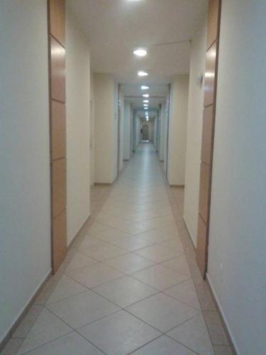 a hallway of a building with a tile floor and a long corridor at Harbor Self Graciosa Hotel in Quatro Barras