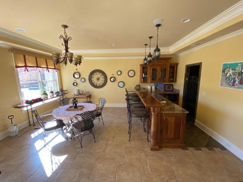 a kitchen and dining room with a table and chairs at Vacation Retreat with Pool, Gym, Kitchen in Sugar Hill