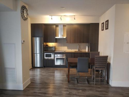 a kitchen with a table and chairs in a room at Entertainment District, Downtown Toronto - 300 Front 1 Bed 1 Bath, City View in Toronto