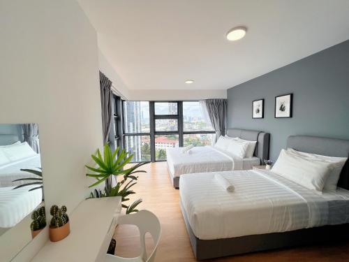 a hotel room with two beds and a window at EkoCheras Designer Suite by Moka @ Cheras in Kuala Lumpur