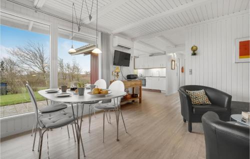 a kitchen and dining room with a table and chairs at Stunning Home In Hurup Thy With Wifi in Doverodde
