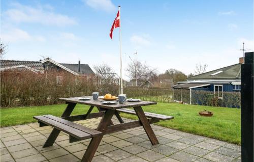 a picnic table with a bowl of fruit and a flag at Stunning Home In Hurup Thy With Wifi in Doverodde