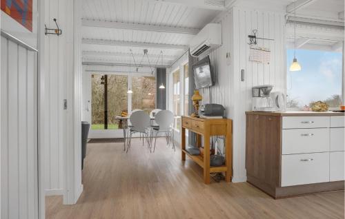 a kitchen and dining room with a table and chairs at Stunning Home In Hurup Thy With Wifi in Doverodde