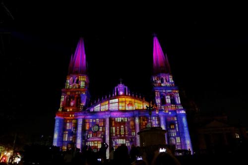 a building lit up in blue and purple at Holiday Inn Hotel & Suites Centro Historico by IHG in Guadalajara