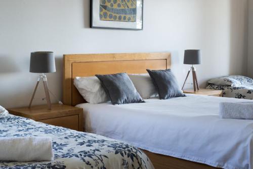 a bedroom with two beds and two lamps at Butmaroo Station in Bungendore