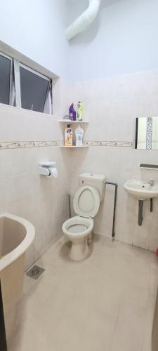 a bathroom with a toilet and a sink at Air-home M9 Simpang near Aulong Econsave, 4BR, 10pax, Netflix in Taiping